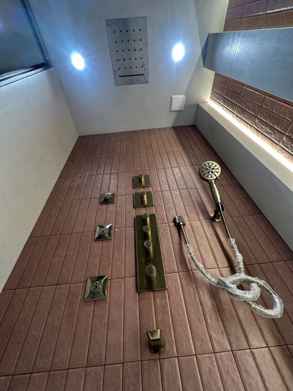 Brushed gold concealed shower system with body jets and ceiling drencher head